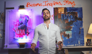 man standing in front of canvases